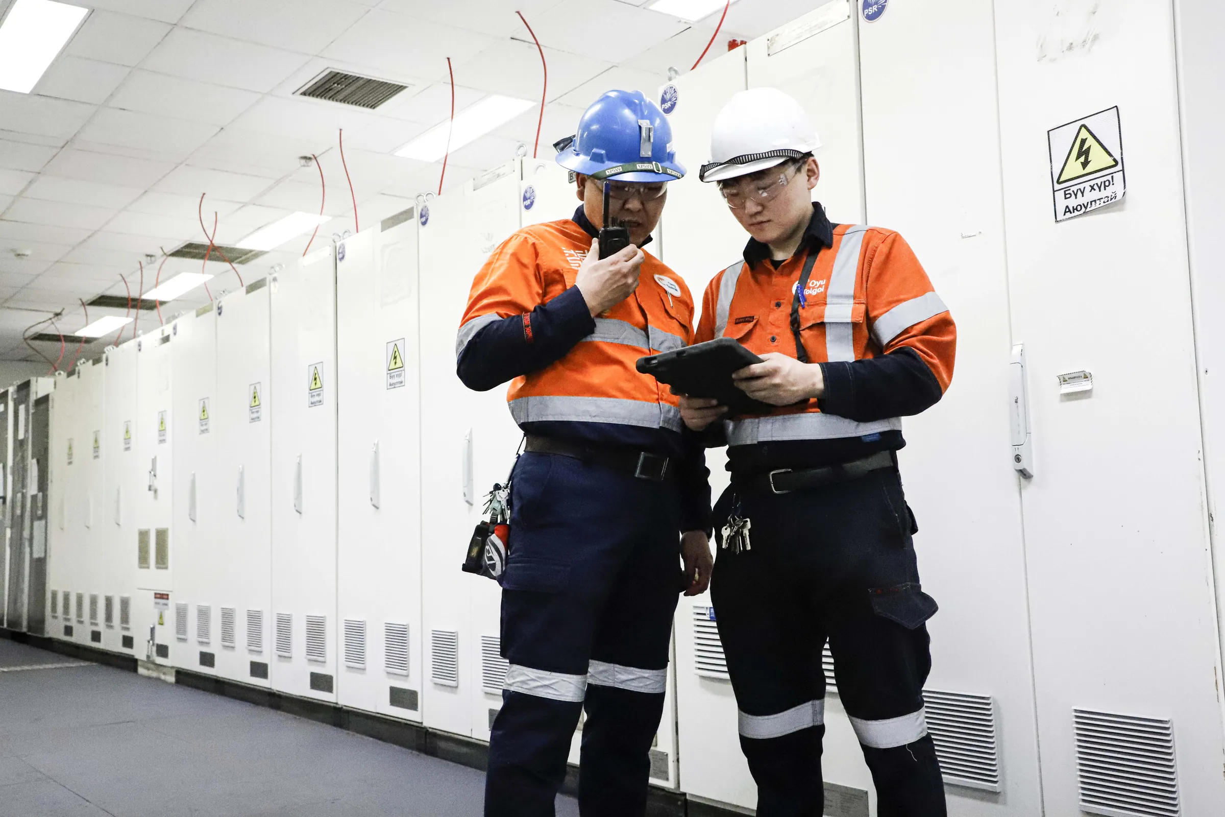 CHP technicians reviewing electrical switchgear