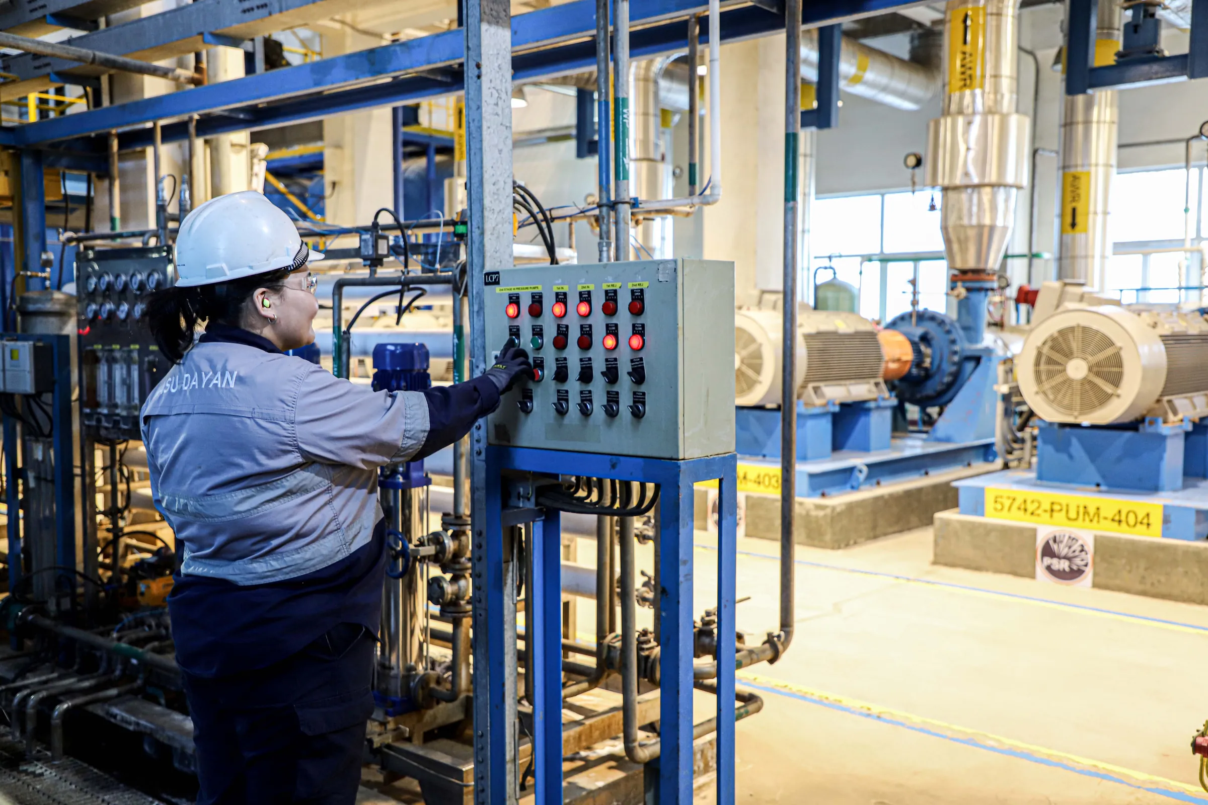 CHP operator checking pump control equipment