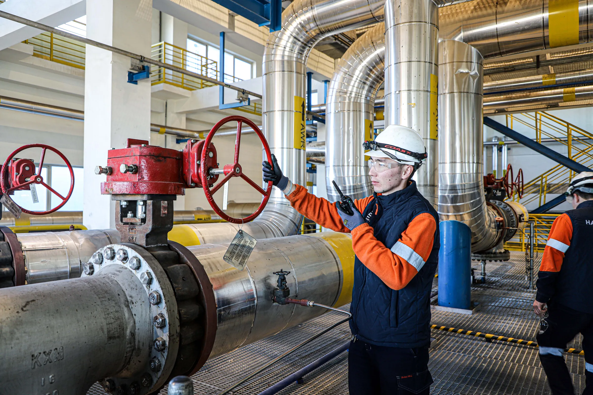 CHP operator inspecting a heating system valve